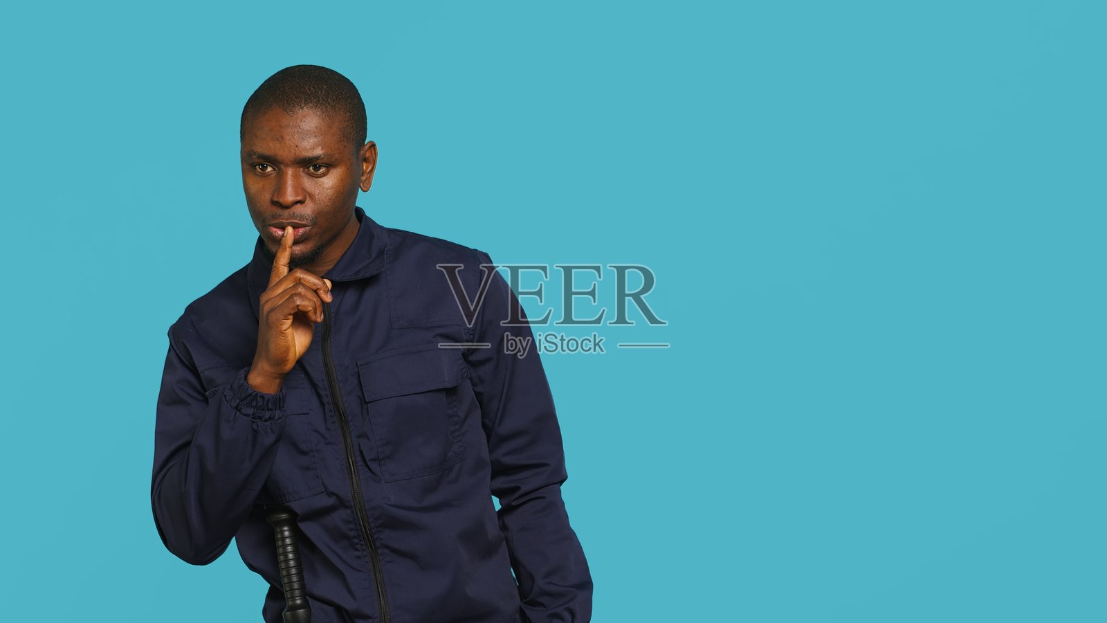 保安做出嘘声手势，手指示意安静照片摄影图片