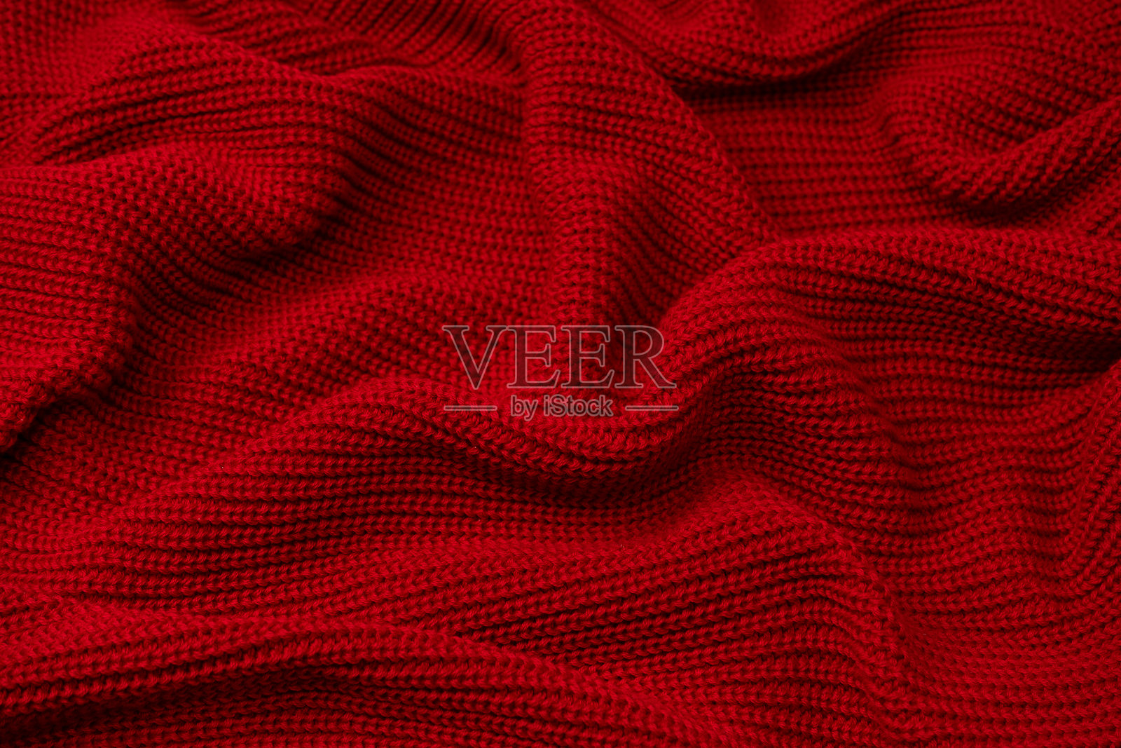 红色毛衣纹理作为背景。照片摄影图片