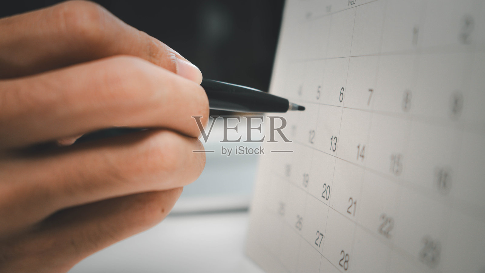 2024年活动策划者时间表议程计划。商务人士在手机上查看计划，正在办公桌上的日历上做笔记。日历事件计划，工作规划。照片摄影图片