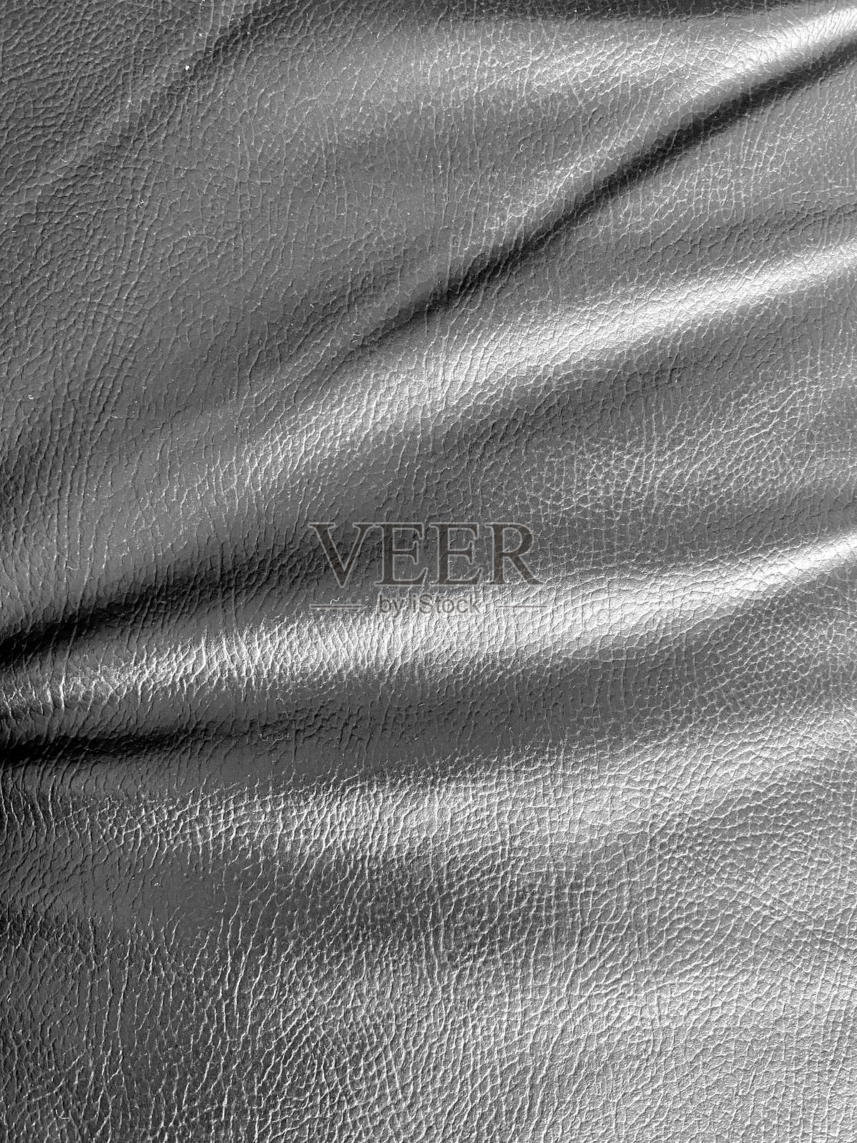 黑色皮革纹理，合成皮，带有精致表面的颗粒材料。粗犷的表面，非常适合背景、奢华设计和高端项目。照片摄影图片