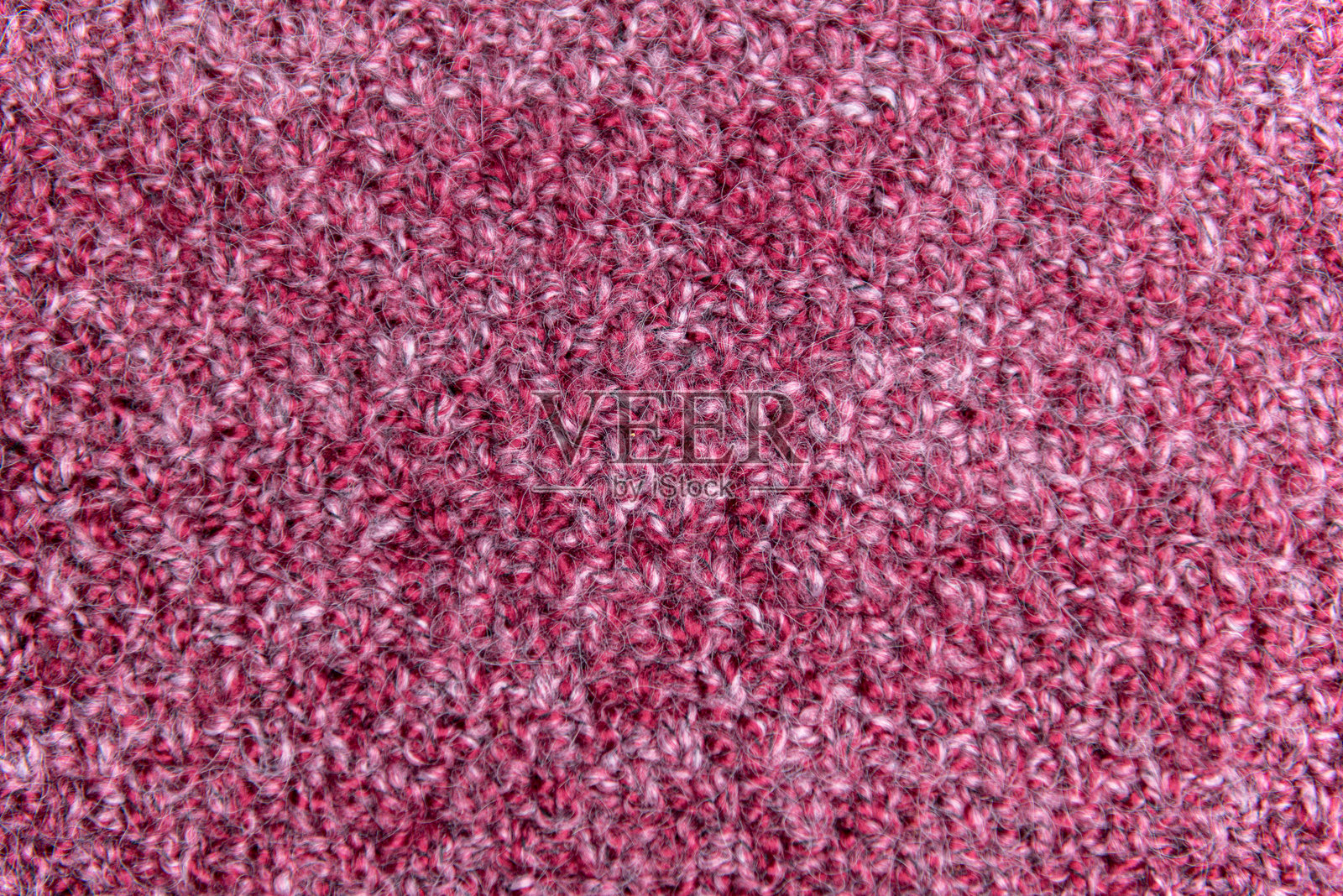 特写镜头展示粉色手工编织的面料，带有大针脚。纹理背景。照片摄影图片