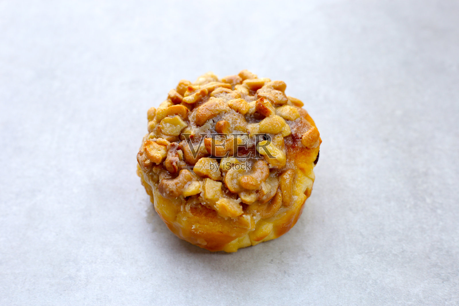 焦糖坚果酥饼，内含葡萄干馅，顶部覆盖焦糖涂层的腰果。照片摄影图片