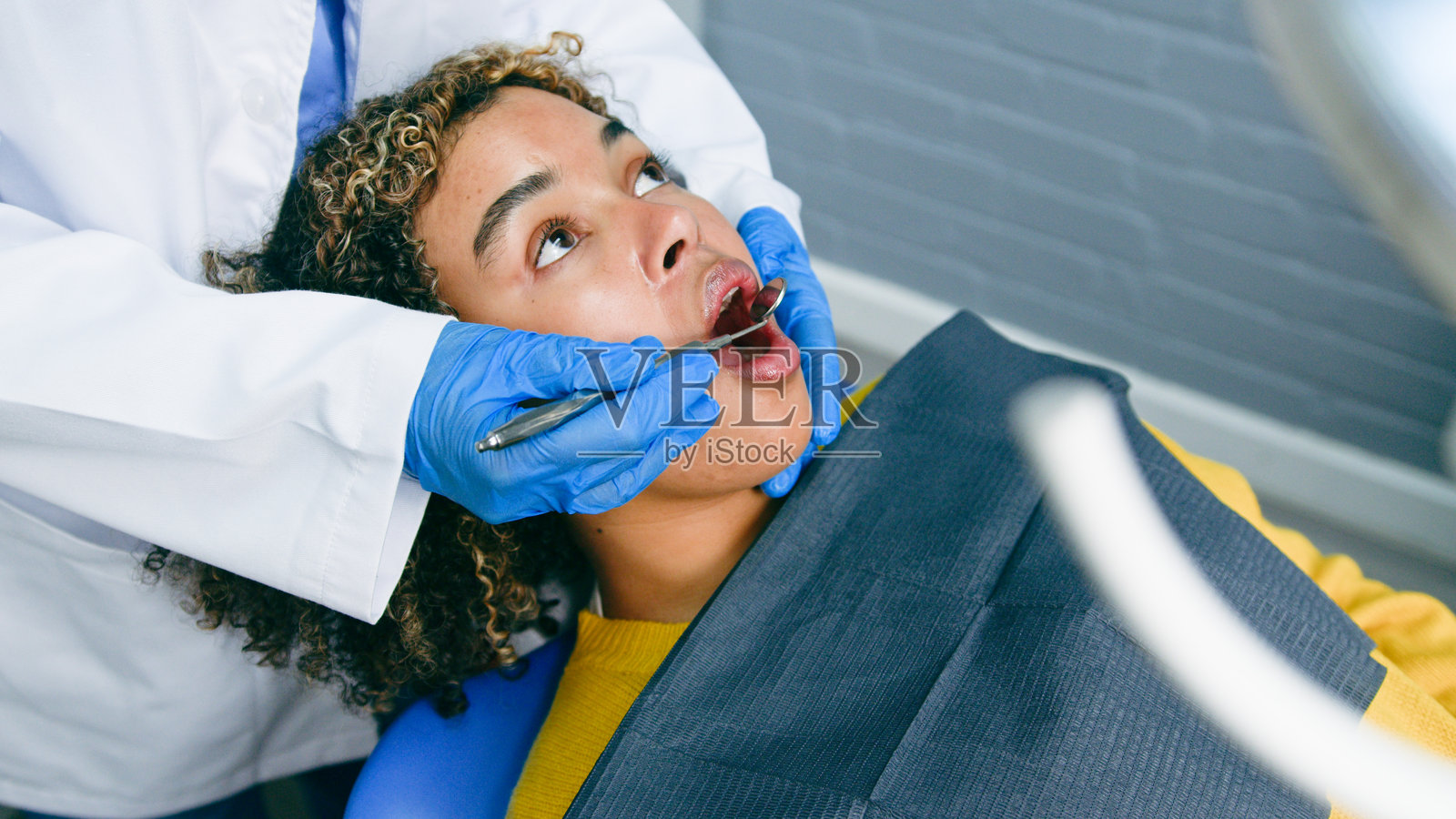 患者在牙科诊所接受专业牙科检查照片摄影图片