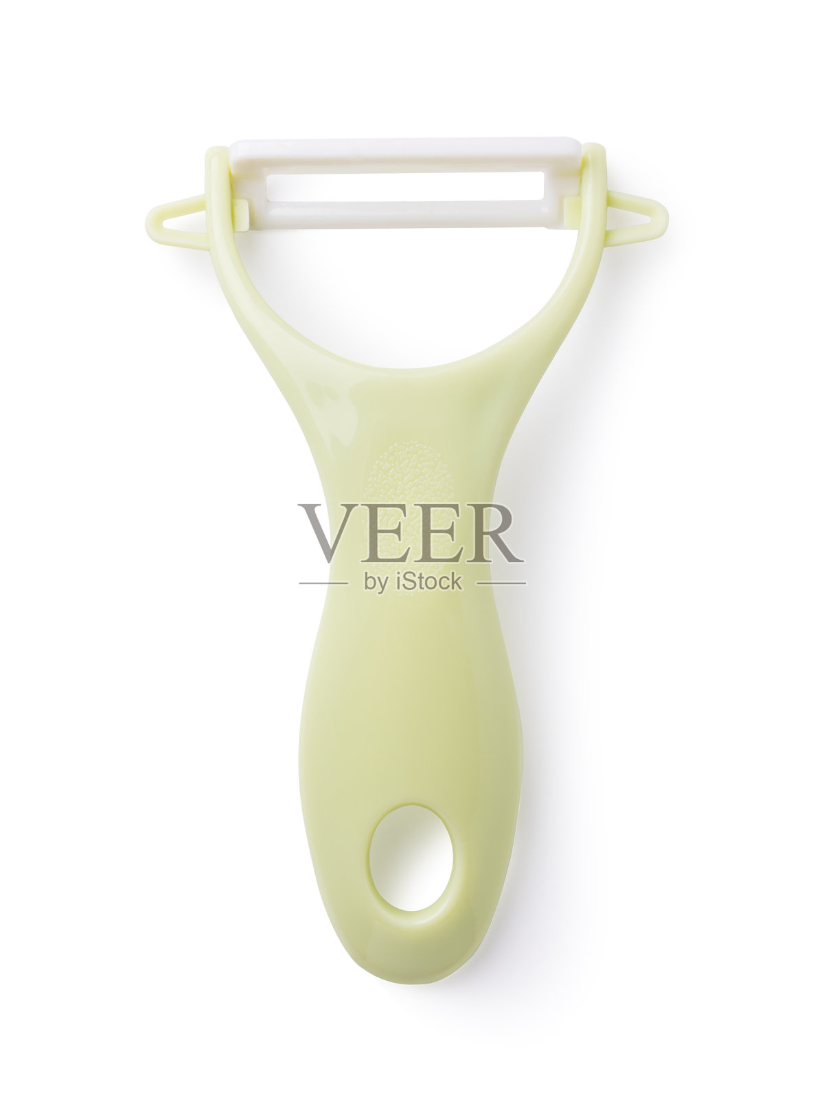 白色背景上的塑料蔬菜削皮器，俯视图照片摄影图片