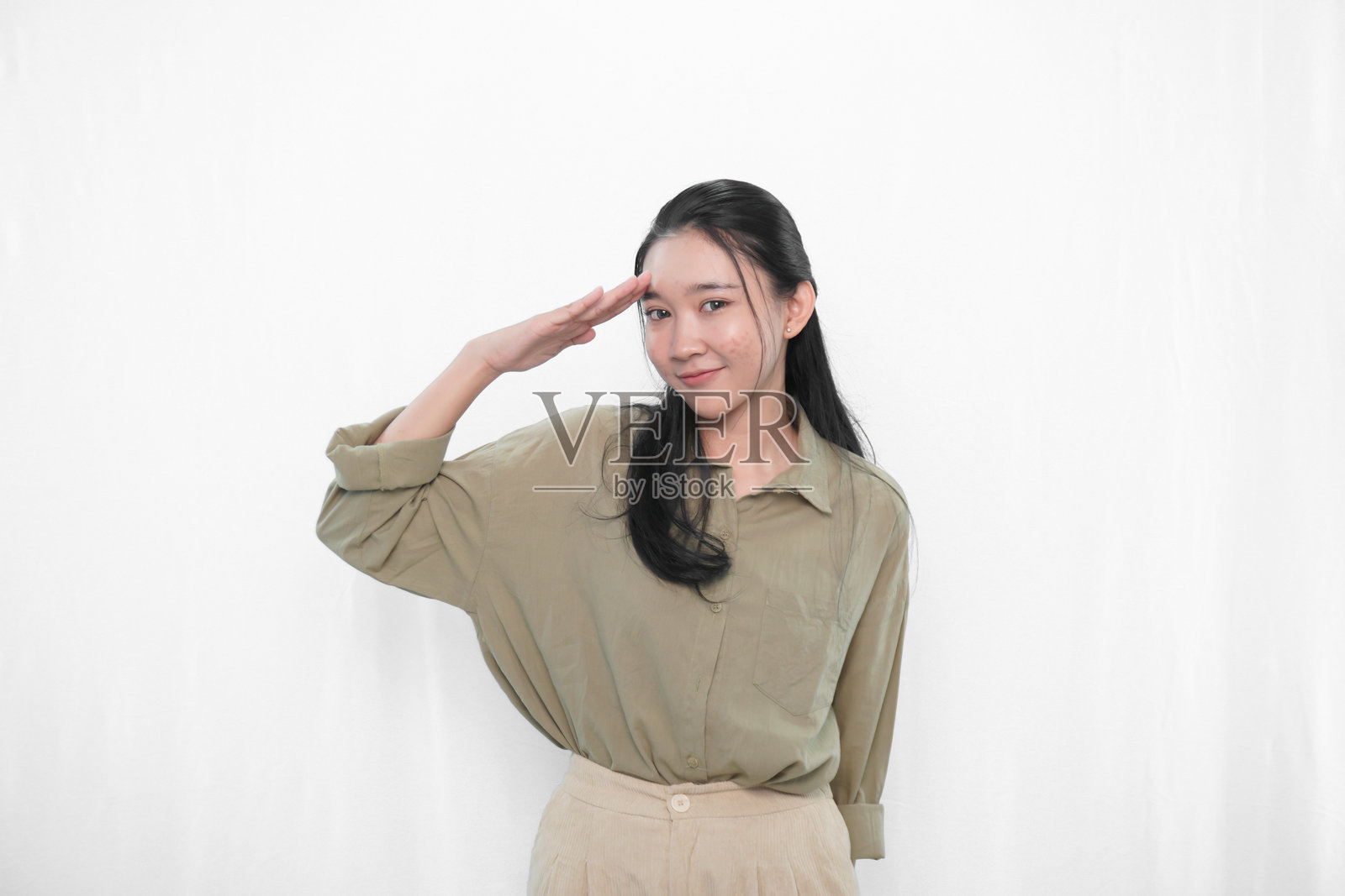 穿着绿色裙子的印尼亚洲女性在摄影棚中的表情照片摄影图片