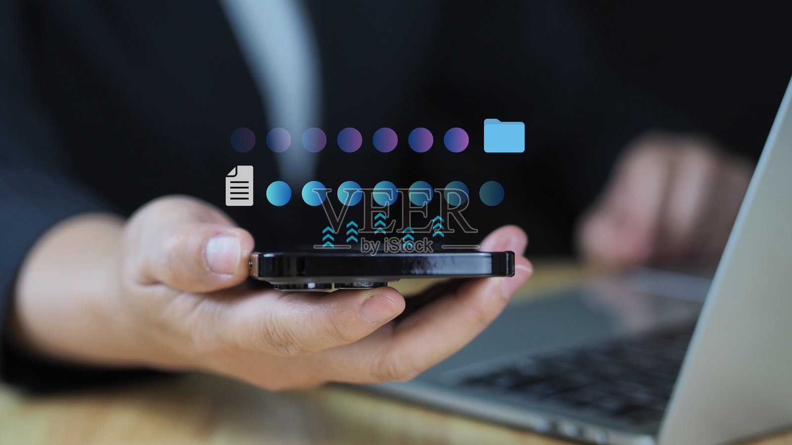 数字技术概念。商人使用智能手机和笔记本电脑传输文档信息数据以备份数据文件。照片摄影图片