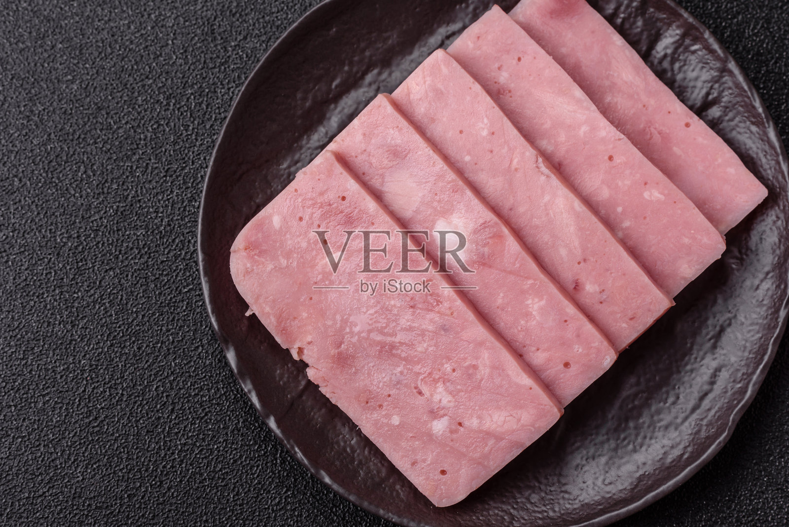 美味的罐装粉红火腿，配有盐、香料和草药照片摄影图片