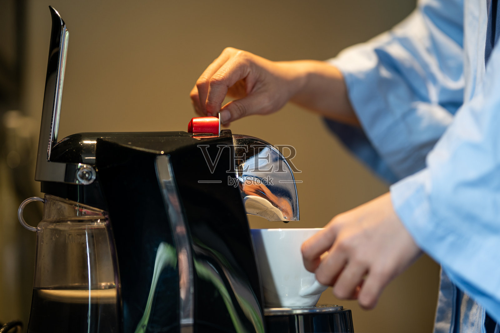 女性在制作胶囊咖啡的特写镜头照片摄影图片