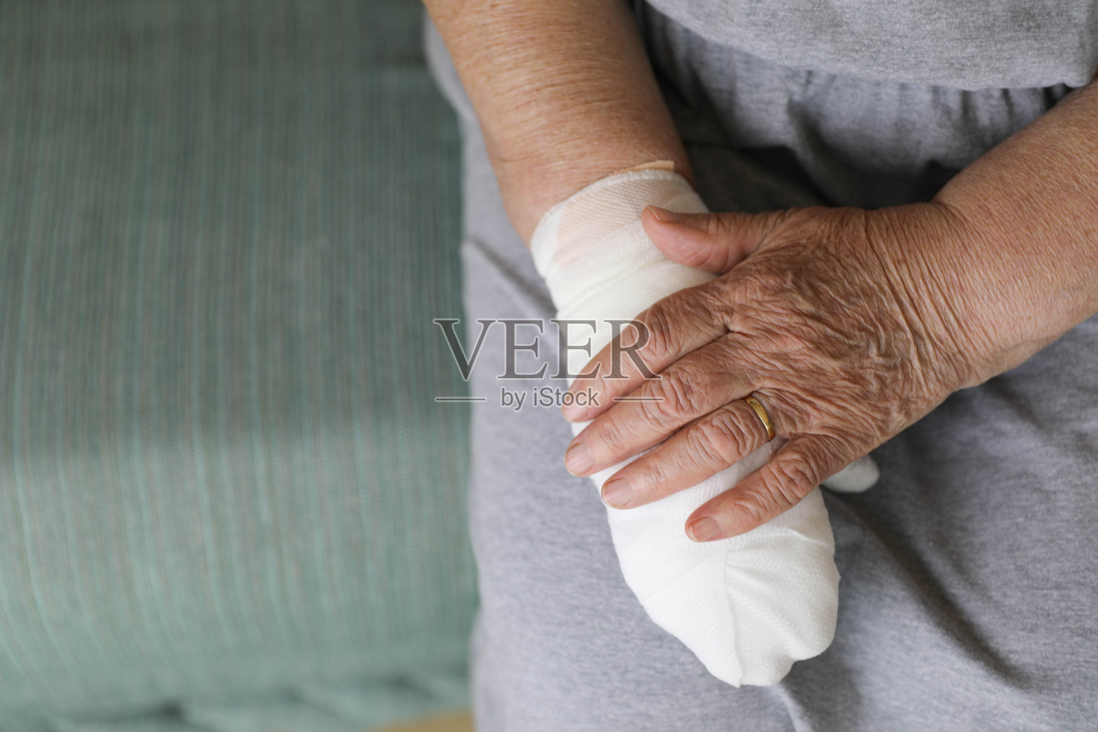 一位年长女性正在努力应对手部受伤照片摄影图片