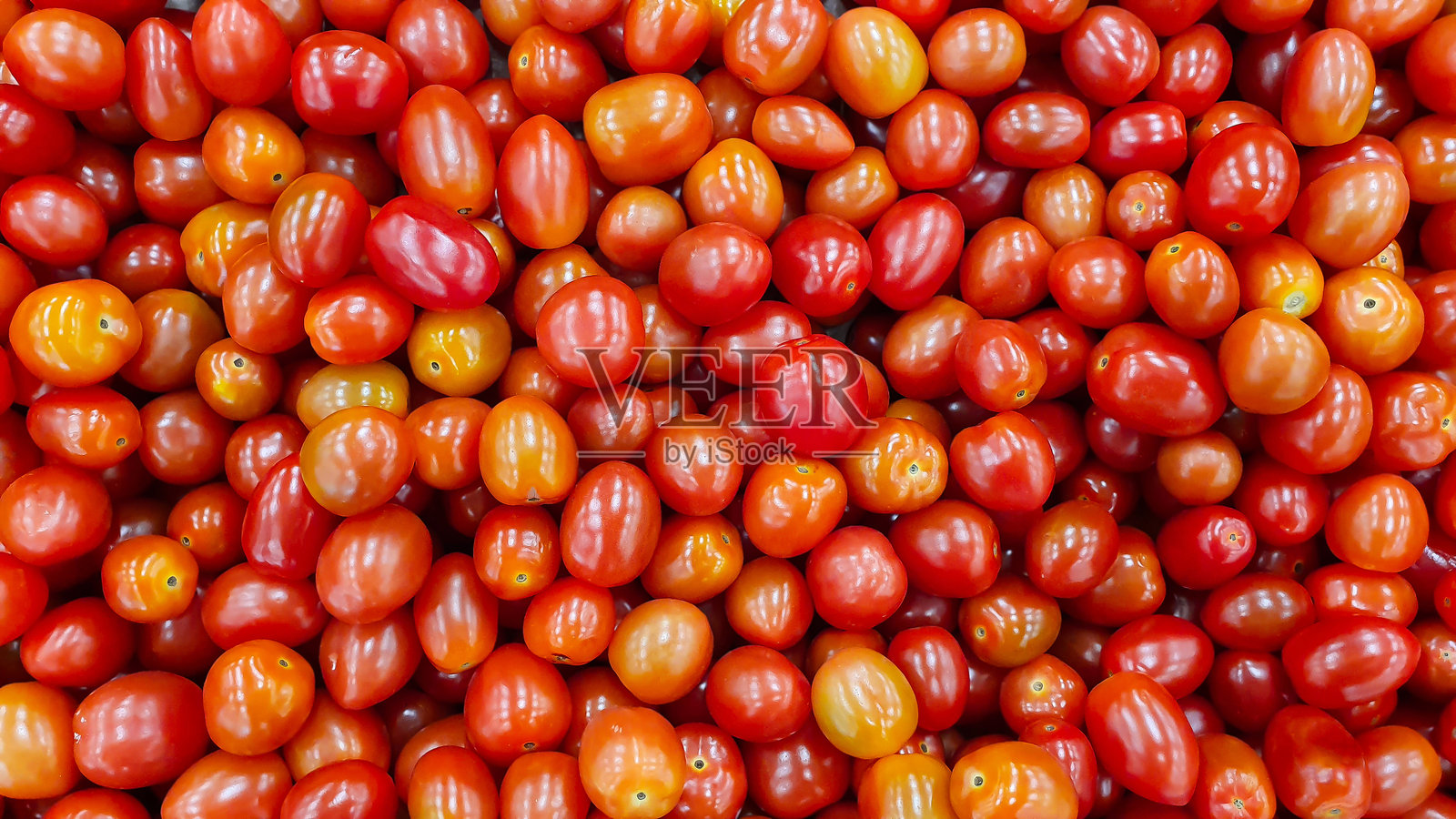 小巧鲜红的番茄俯视图背景图案。照片摄影图片