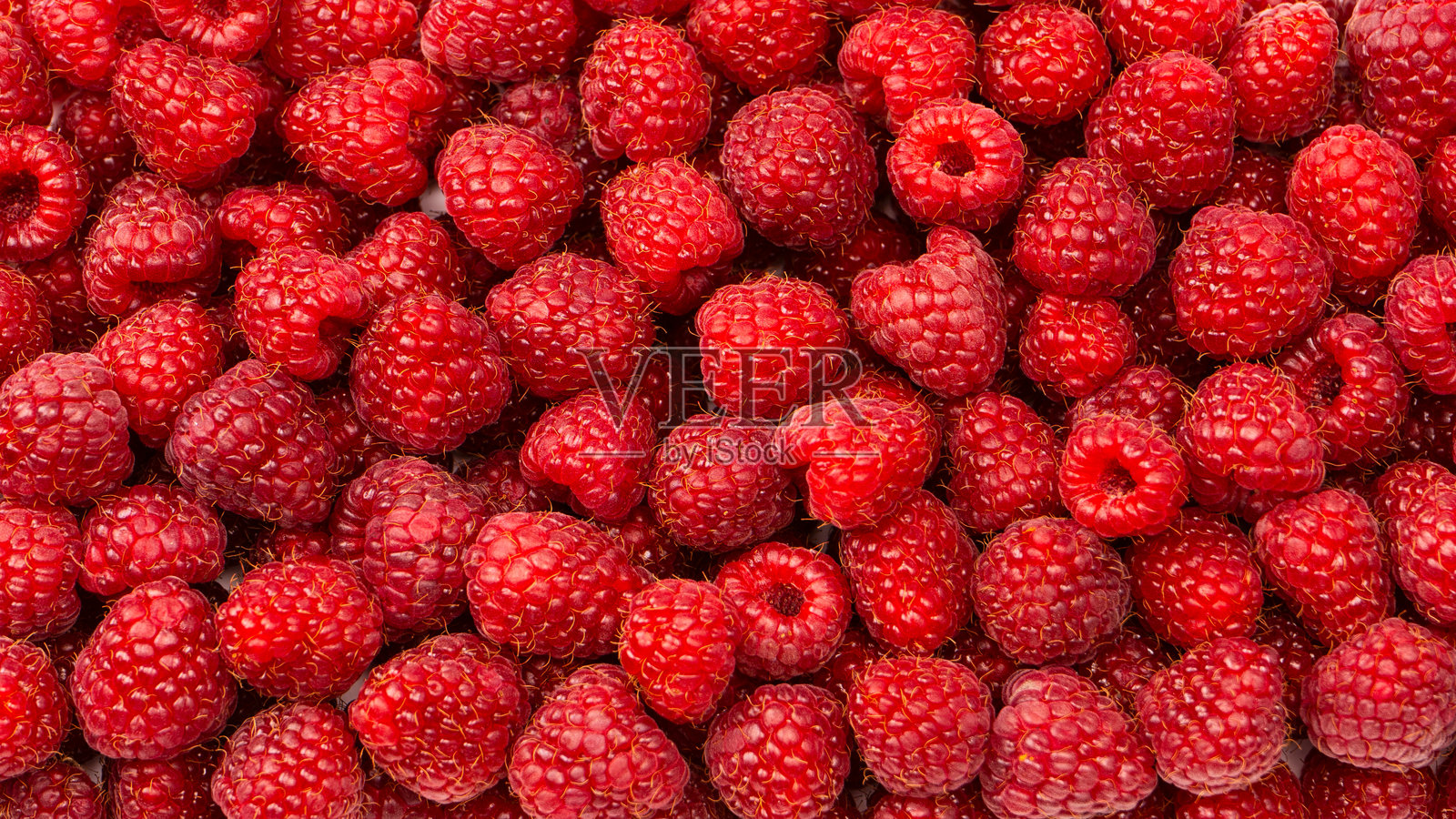 美味的新鲜覆盆子作为背景。照片摄影图片