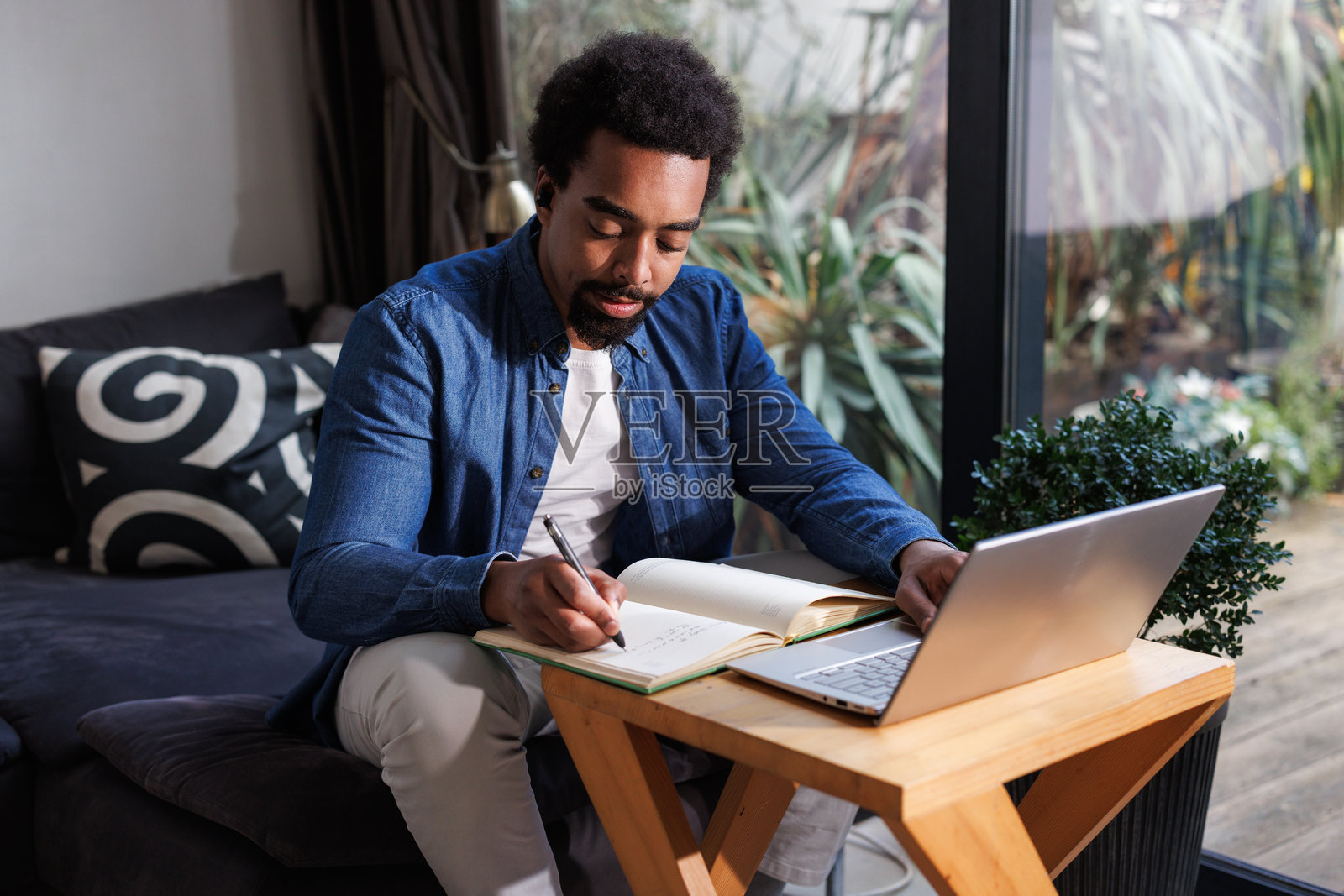 非裔美国男性在舒适的家居环境中工作照片摄影图片
