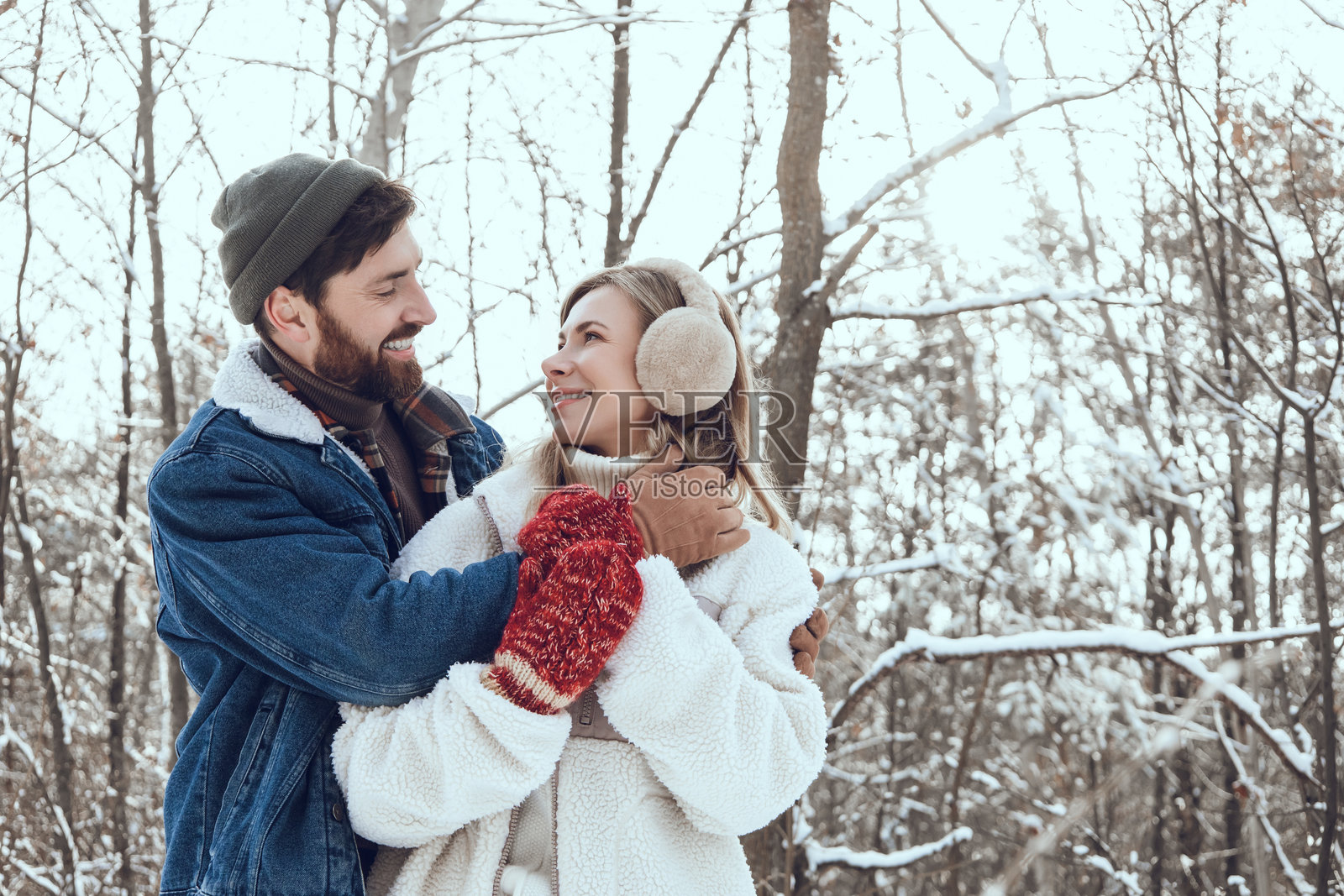 黑发年轻男子拥抱着他的妻子，两人看起来幸福而相爱。照片摄影图片