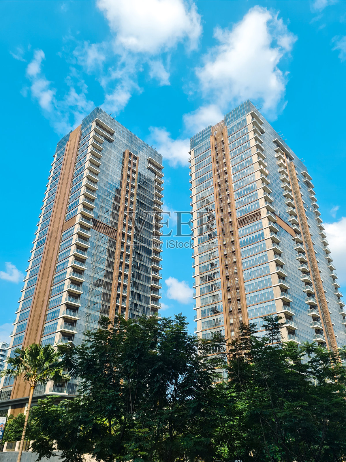 雅加达商业区的双子高楼，玻璃窗映衬着蓝天。照片摄影图片