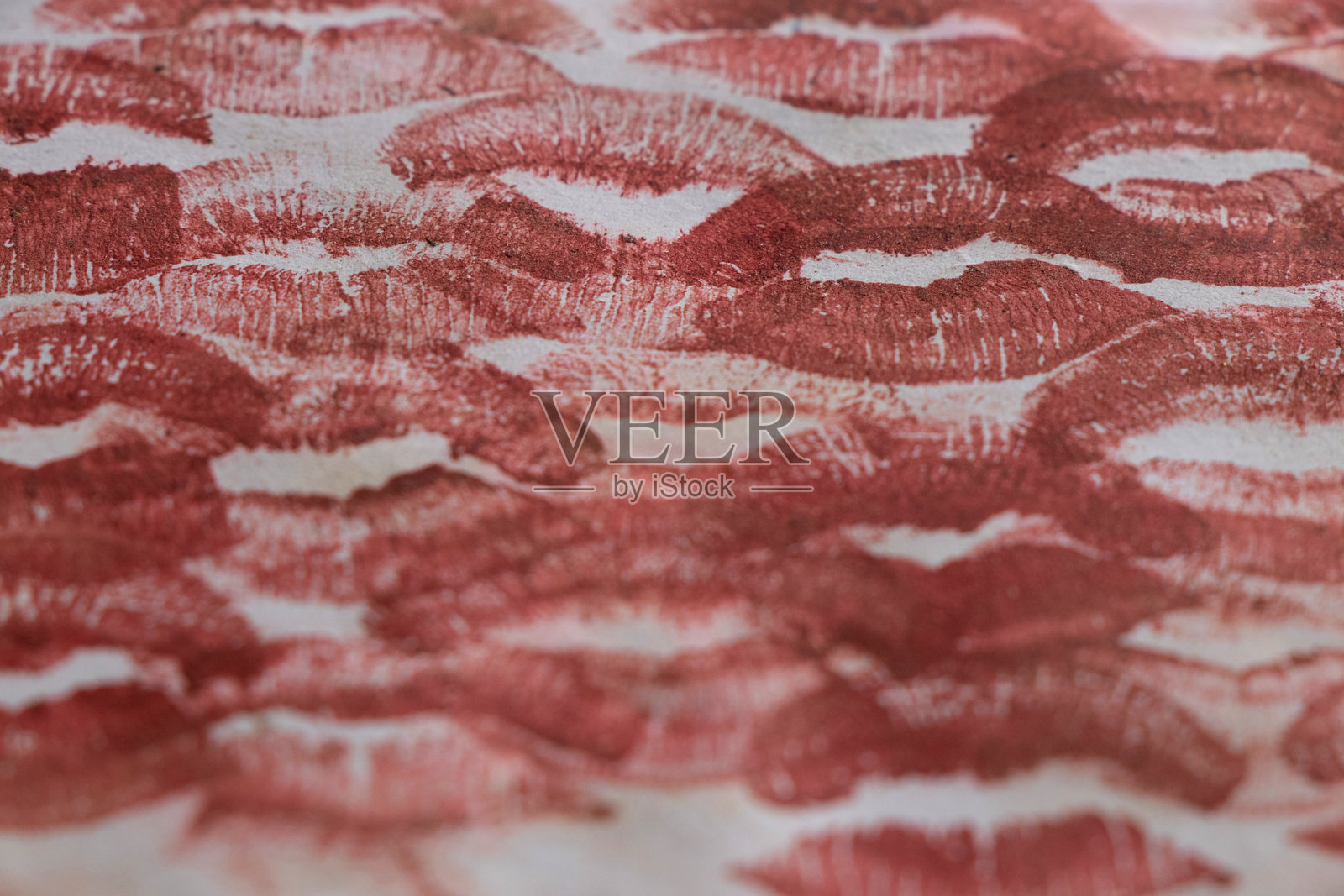 许多用酒红色口红留下的吻痕在白纸上，吻照片摄影图片