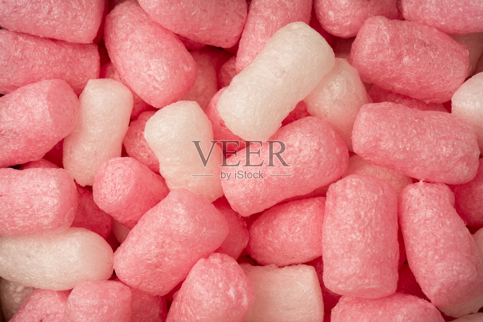 粉色和白色的盒子填充物作为背景。俯视图。照片摄影图片