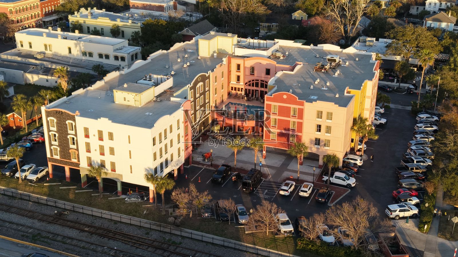 色彩斑斓的城市建筑群及周围的停车场和树木景观照片摄影图片