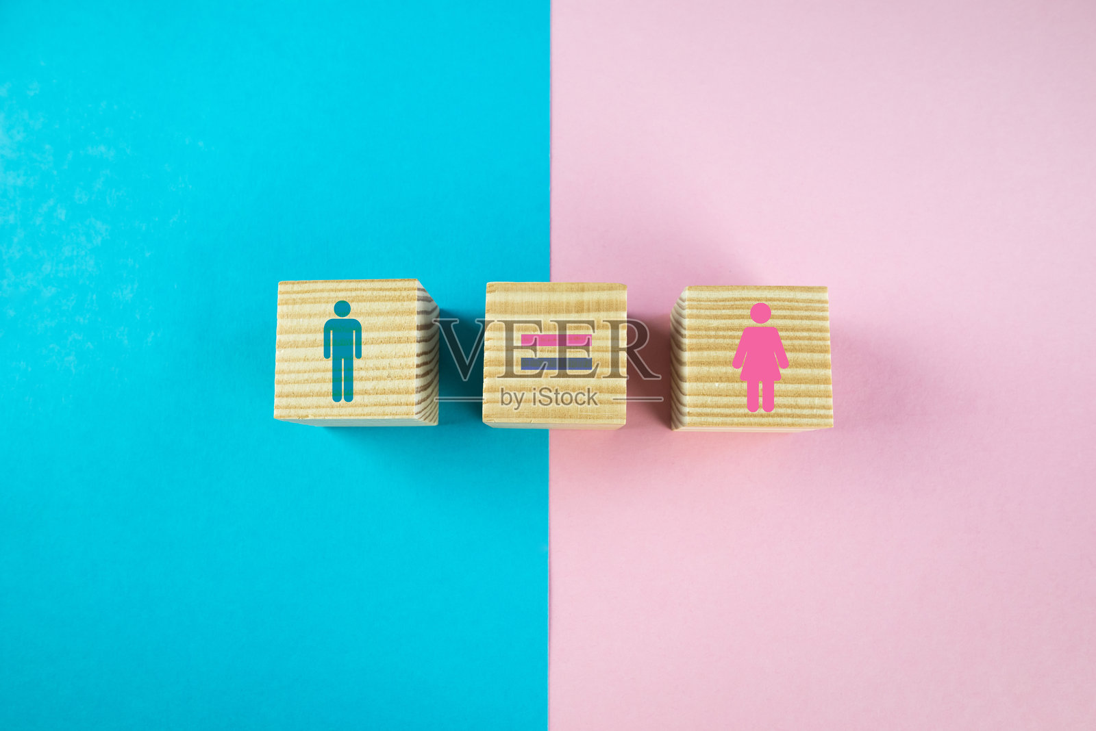性别平等概念。木制方块上有男性和女性符号，背景为蓝粉色。照片摄影图片