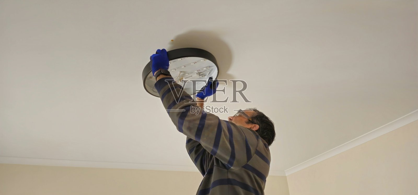 电工正在安装灯具。墨尔本，澳大利亚。照片摄影图片