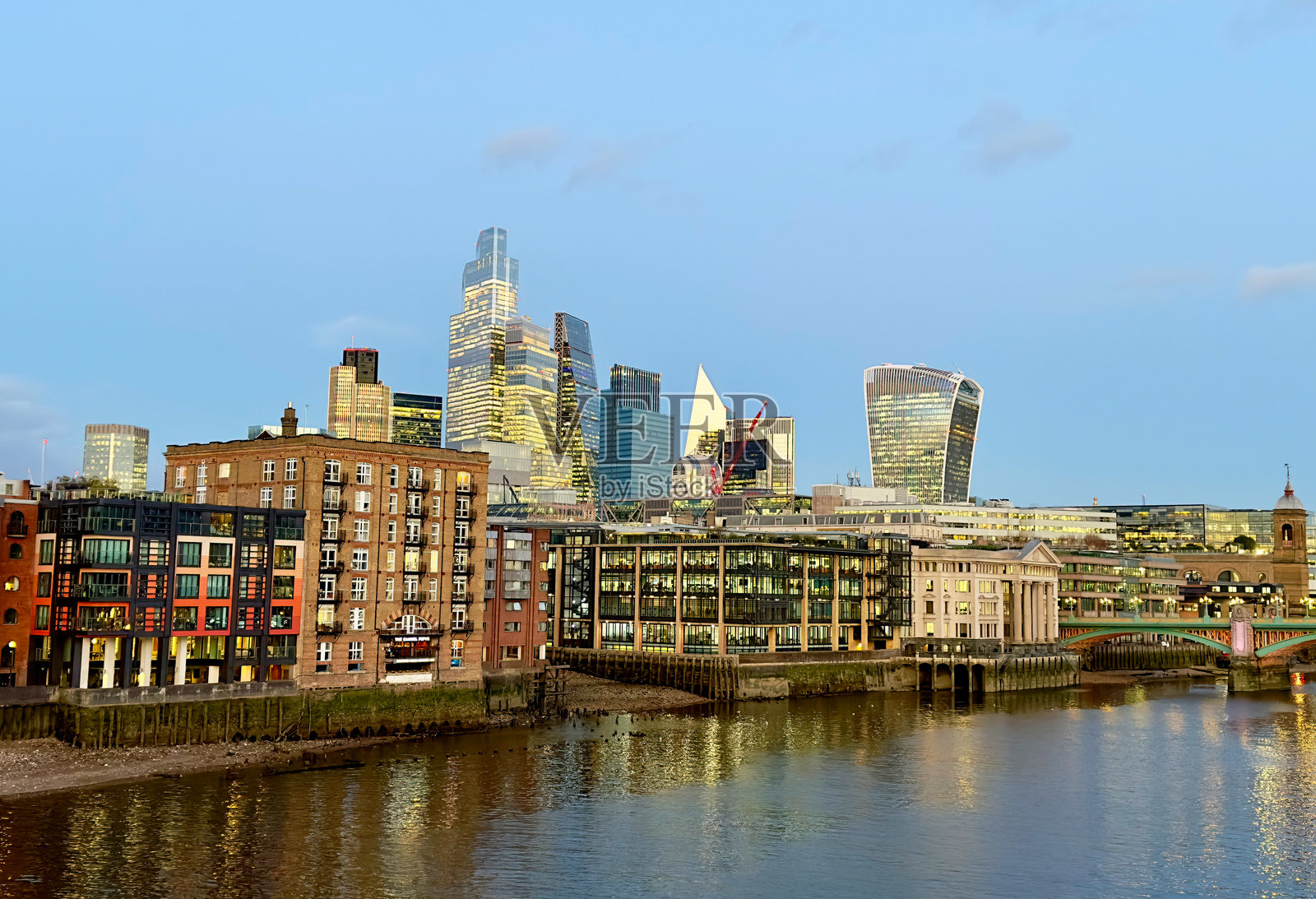 伦敦市中心泰晤士河滨的住宅公寓楼，背景是城市摩天大楼。照片摄影图片