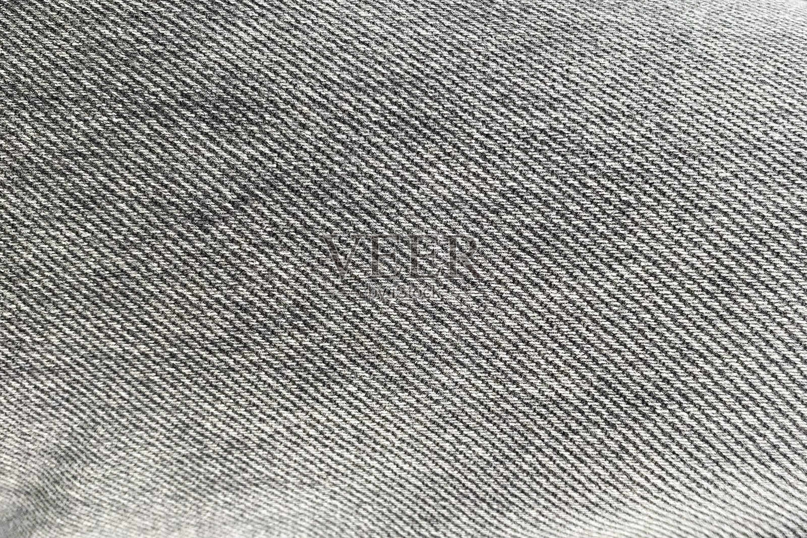 牛仔布料纹理特写背景。黑白色调。照片摄影图片