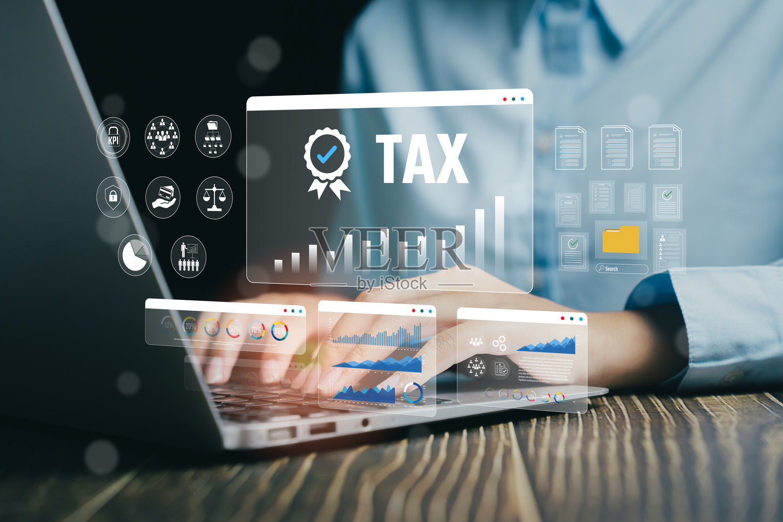 商务专业人士在笔记本电脑上工作，旁边有税务图形和统计数据可视化，商业概念照片摄影图片