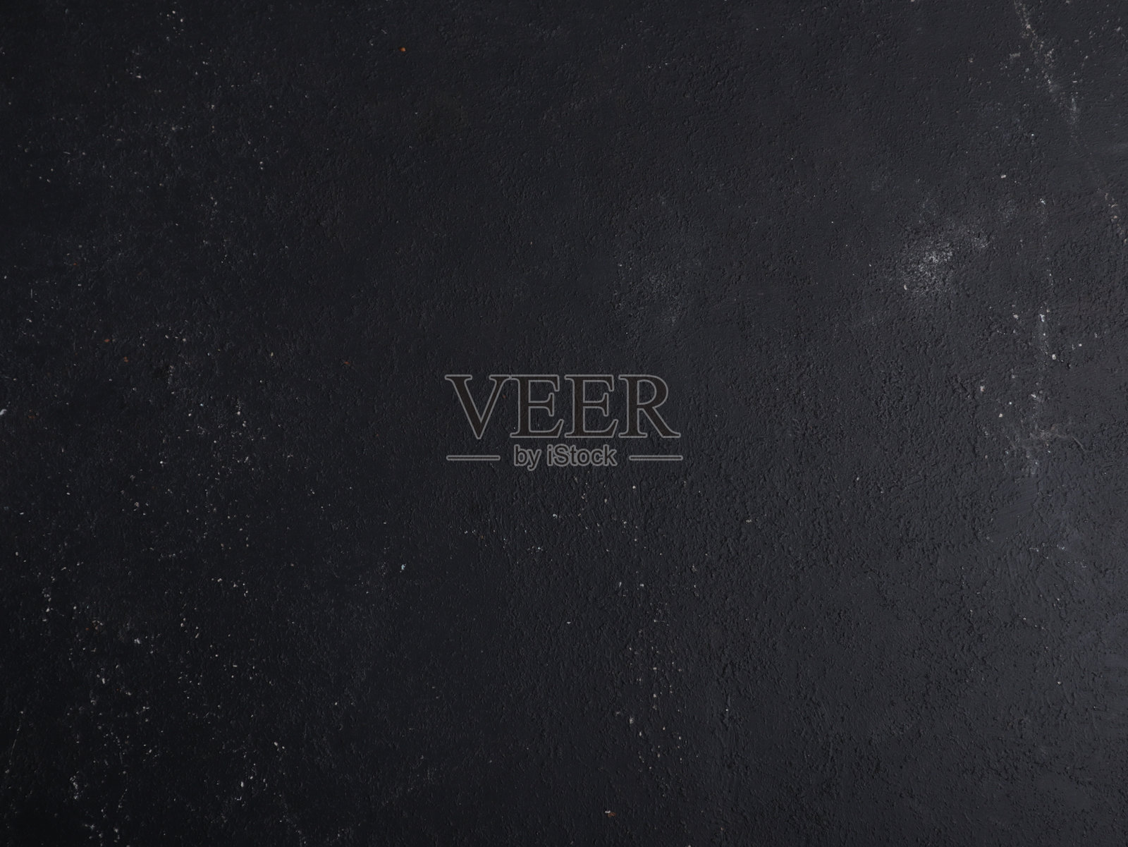 深色哑光黑墙面，带有细微纹理和散落的白色斑点，适合用于颓废风格设计、现代布局、产品模型或极简创意背景。照片摄影图片