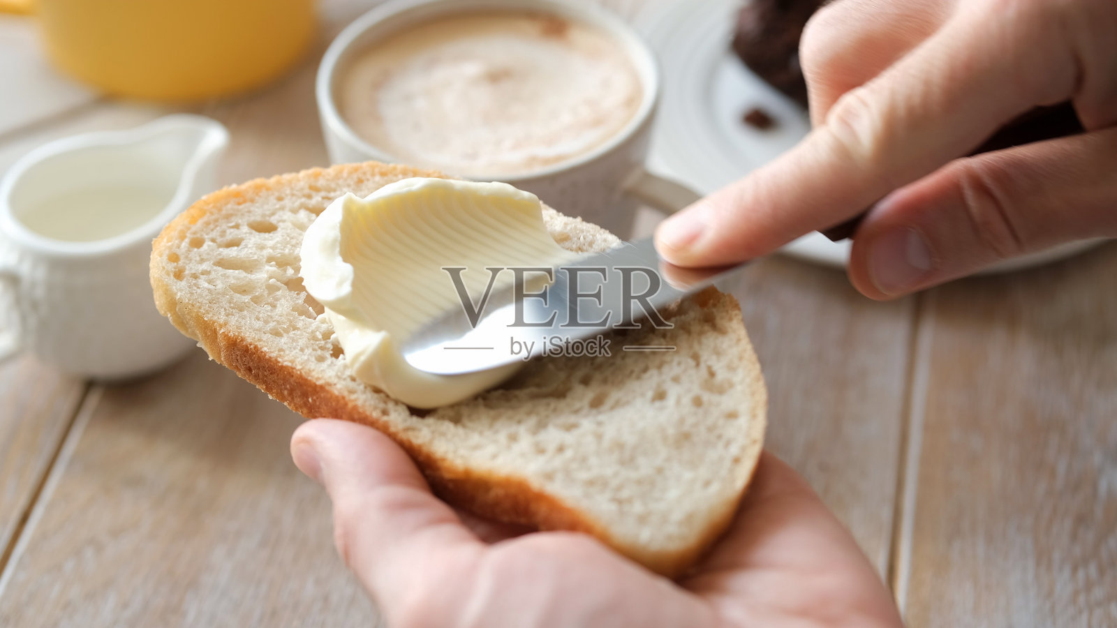 在白面包吐司上涂抹软黄油照片摄影图片
