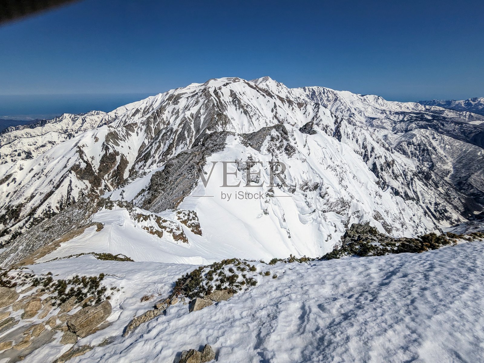 四月时在日本长野县白马的唐松岳上，看到的在返不去之剑后面的白马三山。照片摄影图片