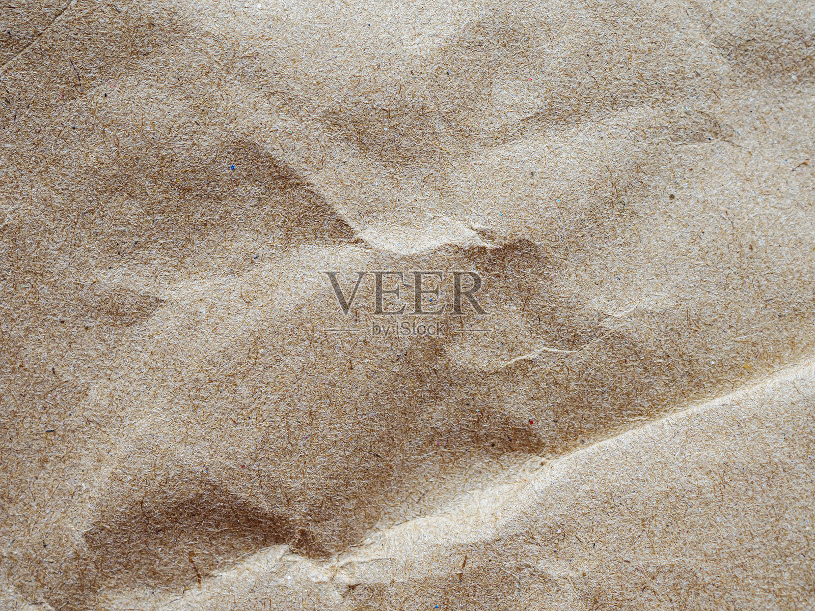 棕色背景，带有皱纹纸质感。背景呈自然棕色，具有皱纹和纹理的外观。浅棕色背景。照片摄影图片