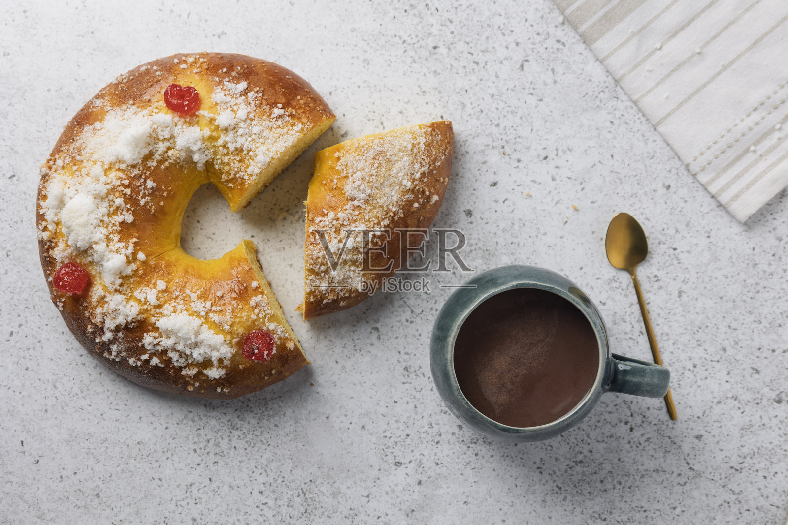 部分切开的传统国王蛋糕配上一杯热巧克力照片摄影图片