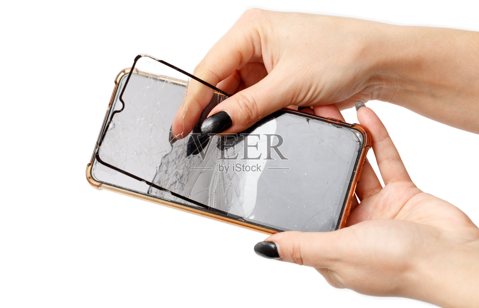 一个人手里拿着一部屏幕破裂的手机照片摄影图片