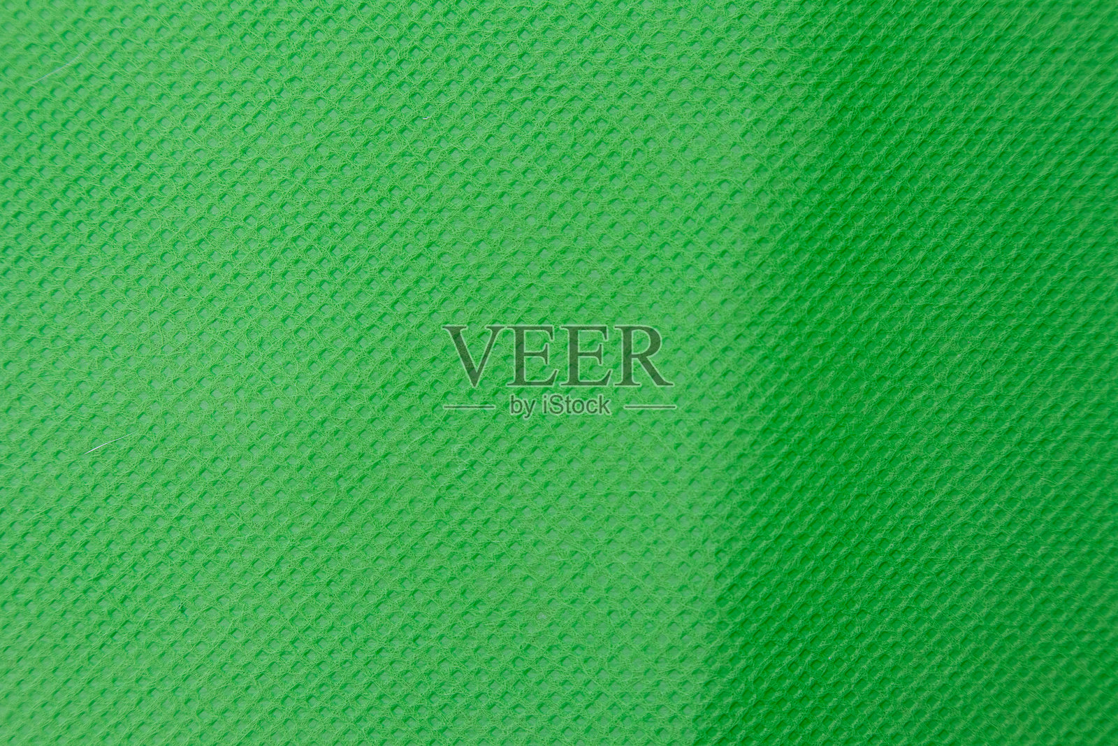 绿色纹理背景形成一条对角线，分隔两种不同深浅的绿色。照片摄影图片