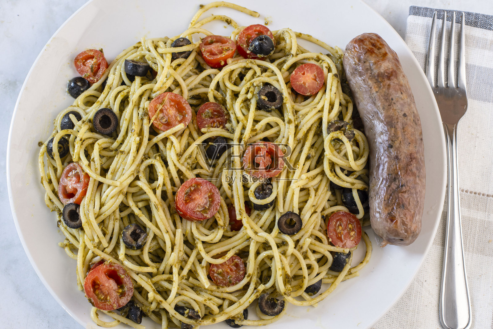 意大利面配番茄、橄榄和香肠照片摄影图片
