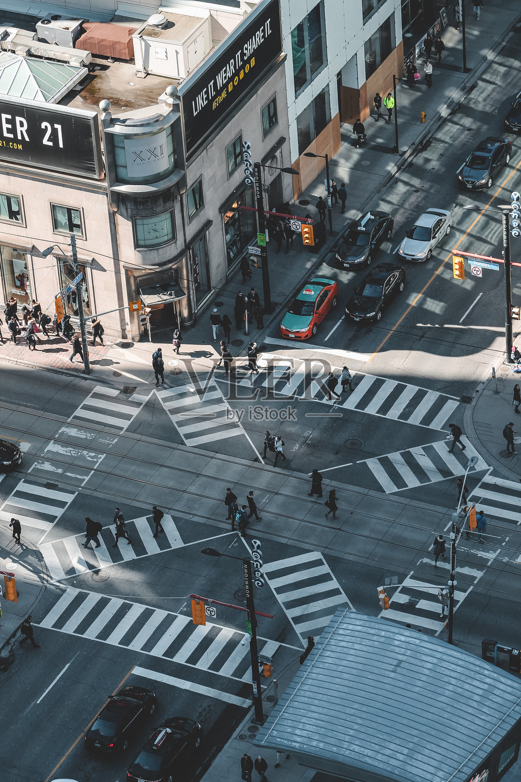 多伦多繁忙交叉口的鸟瞰图，角落有Forever 21商店，行人在多个斑马线上穿行，交通流动。照片摄影图片