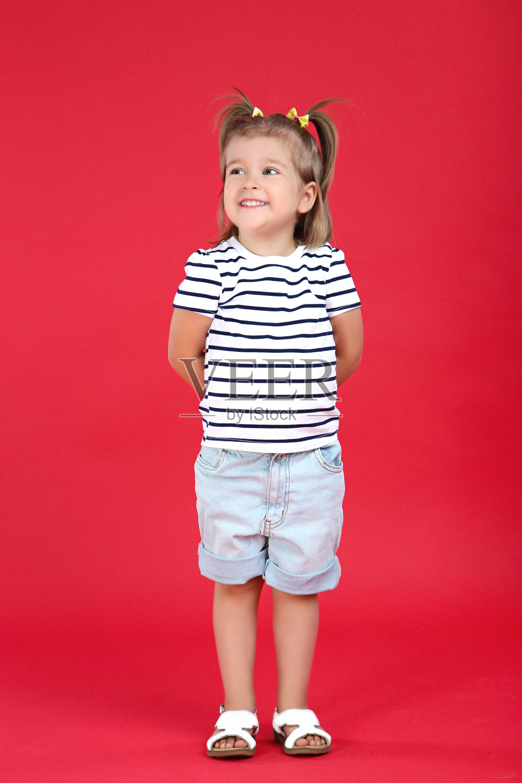 可爱的小女孩在红色背景上照片摄影图片