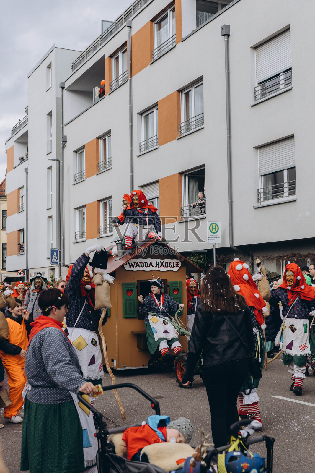德国施瓦宾格穆特，2024年2月13日。狂欢节游行，身穿服装的人们在街上行走。照片摄影图片