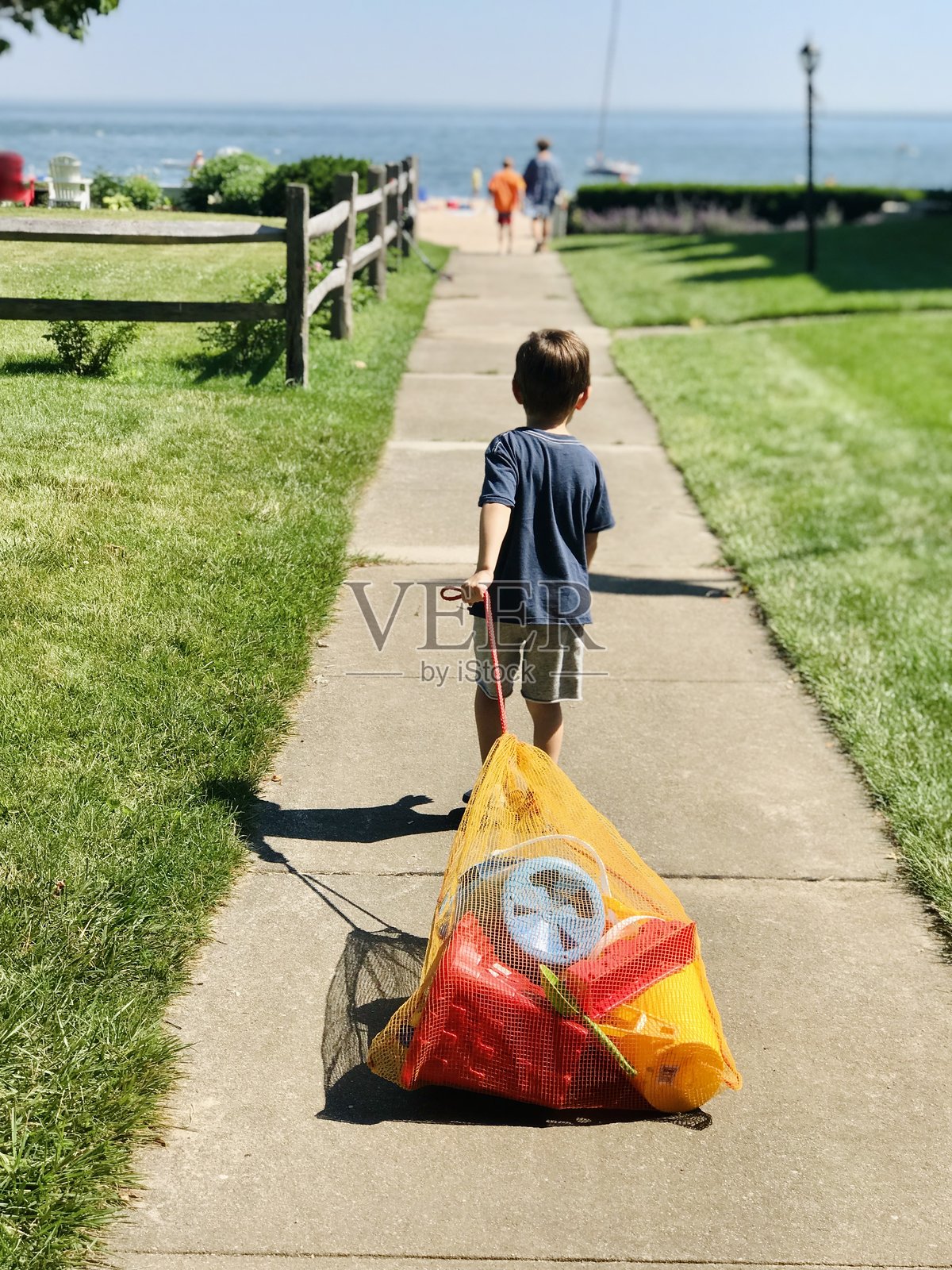 男孩走向海滩照片摄影图片