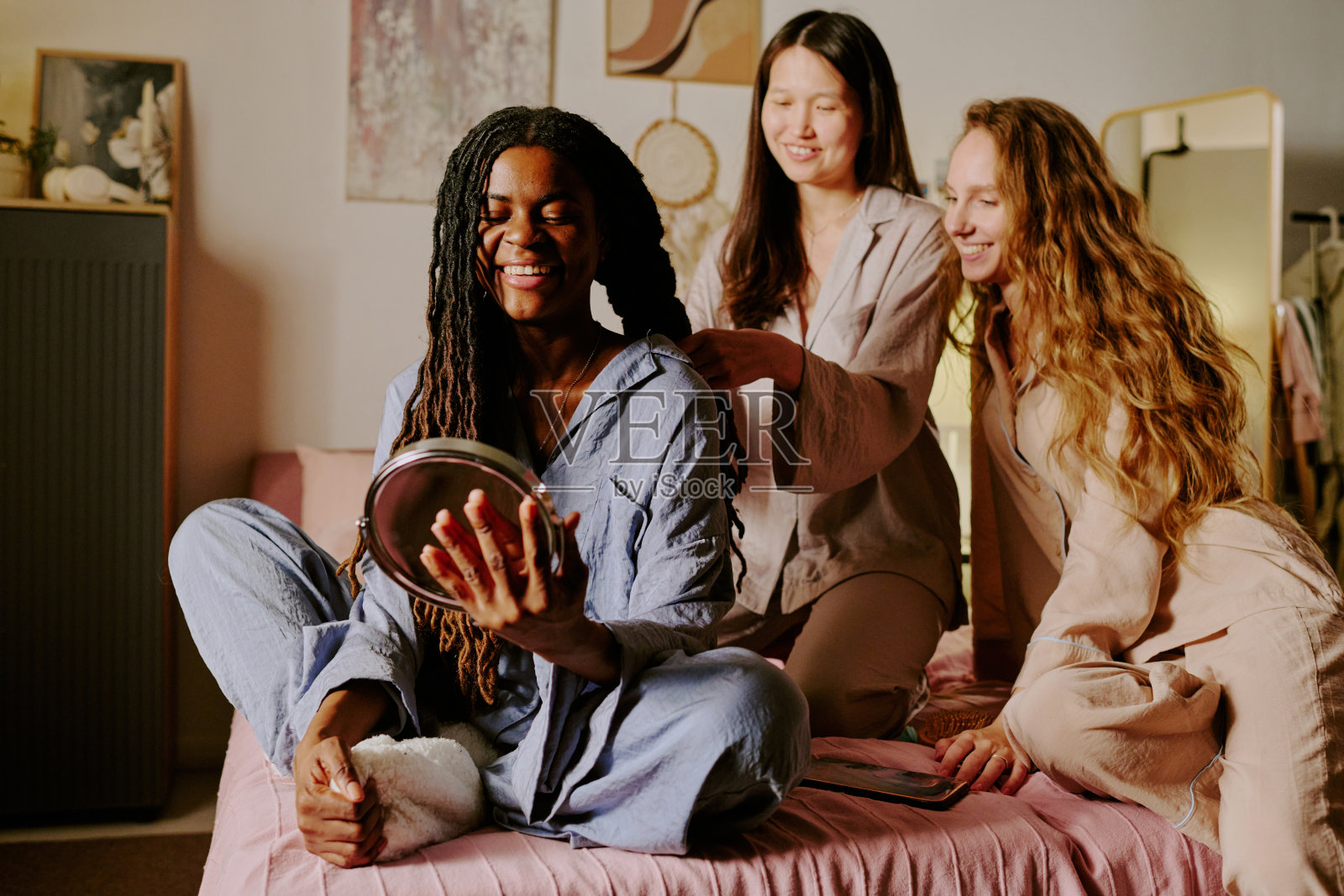 微笑的女人在床上欣赏镜中的自己照片摄影图片