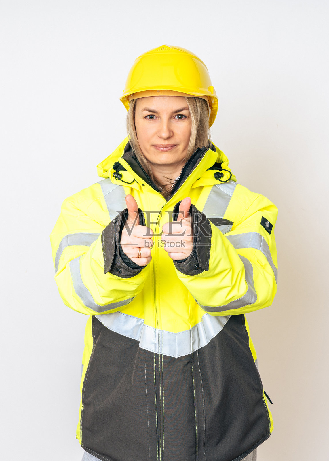 一个穿着黄色特殊防护夹克和黄色安全头盔的女孩照片摄影图片