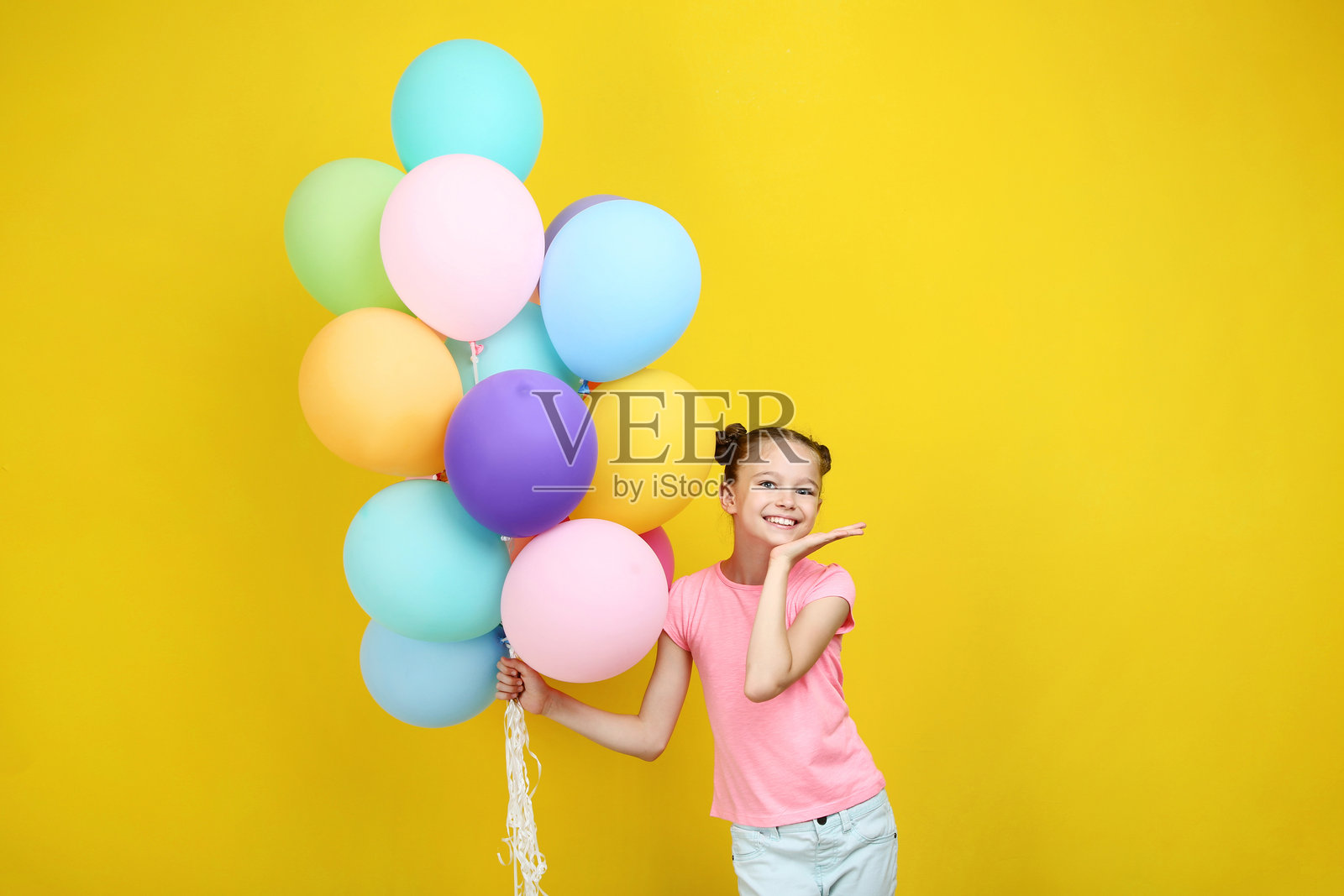 美丽的年轻女孩与彩色气球在黄色背景上照片摄影图片
