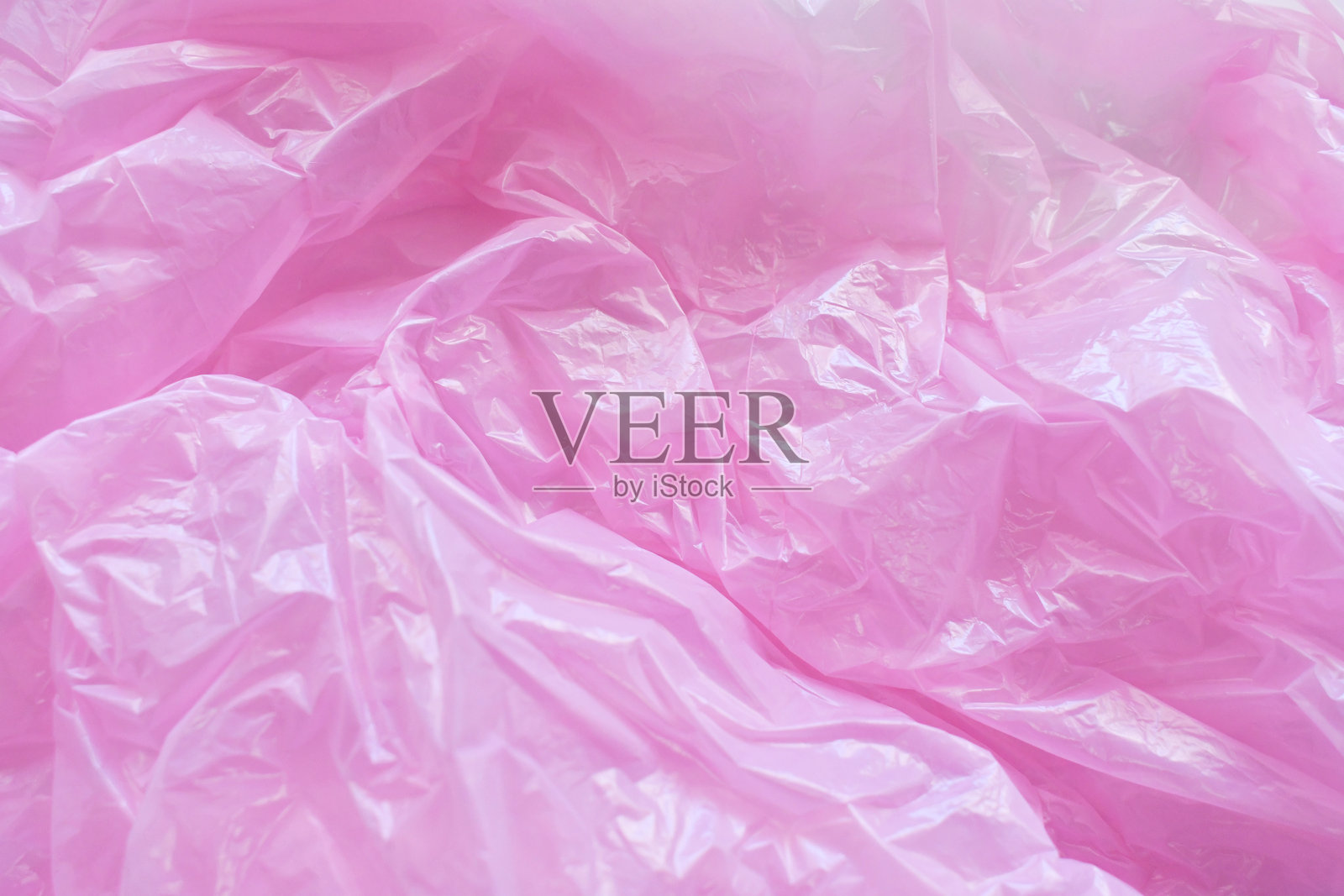 粉色塑料袋纹理背景。照片摄影图片