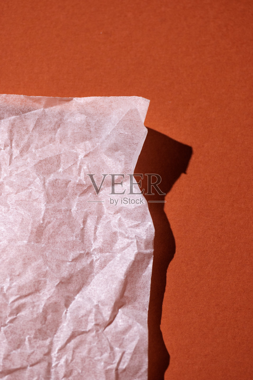 温暖的橙色背景上有一张白色空白纸张。俯视图，舒适的极简风格，温暖的色调，留有文字空间。照片摄影图片