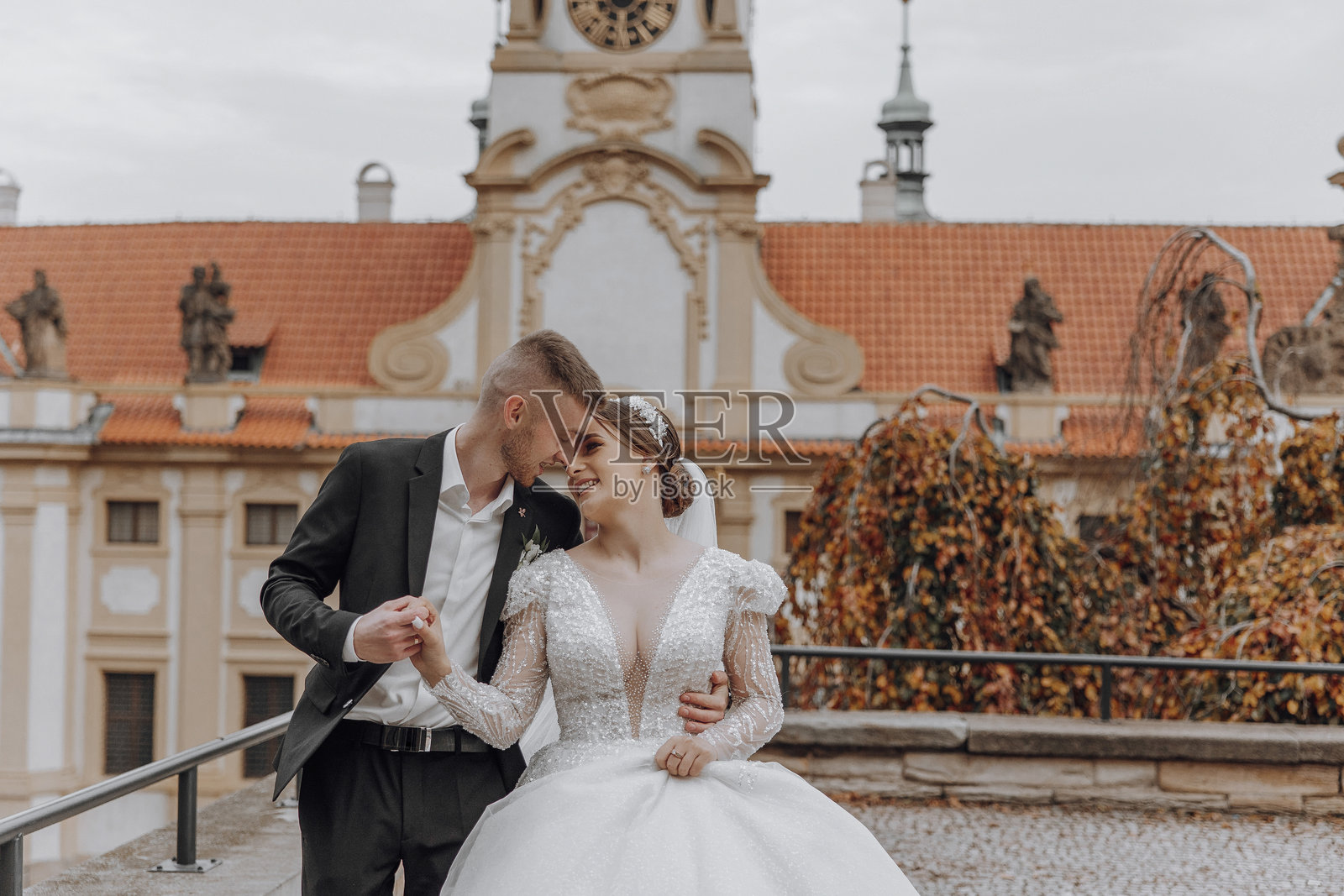 一对新郎新娘站在建筑物的阳台上照片摄影图片