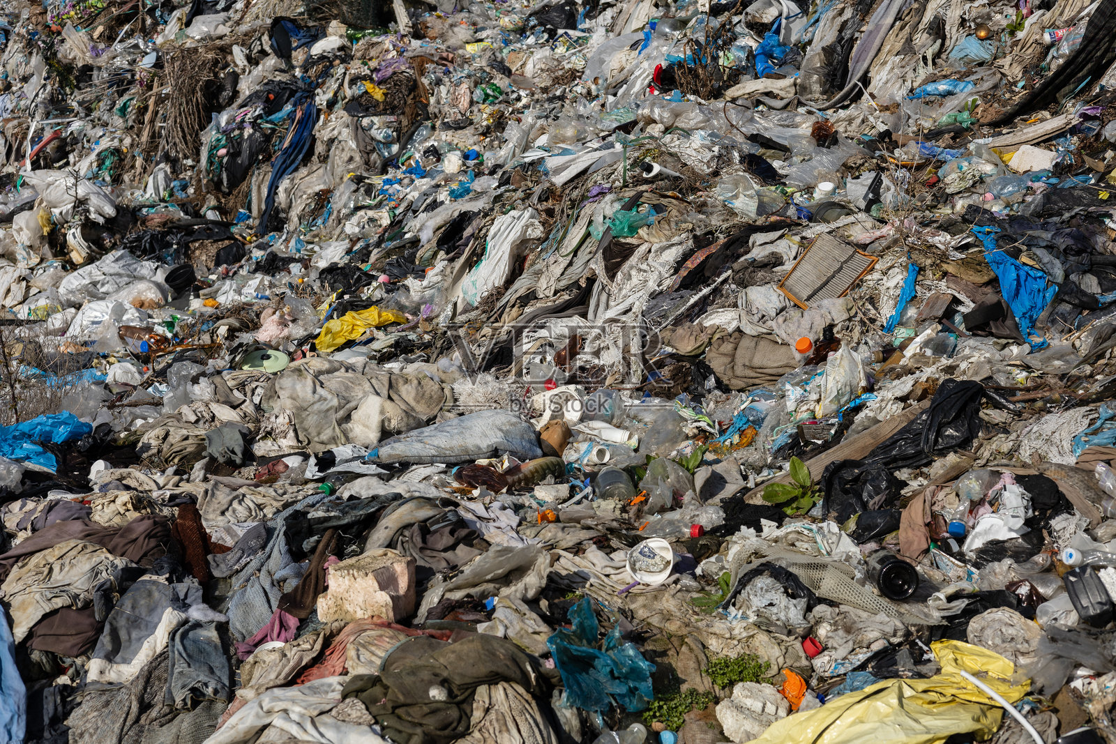 一片广阔的混合垃圾和废物覆盖着垃圾填埋场，突显了环境挑战和废物积累的影响。照片摄影图片