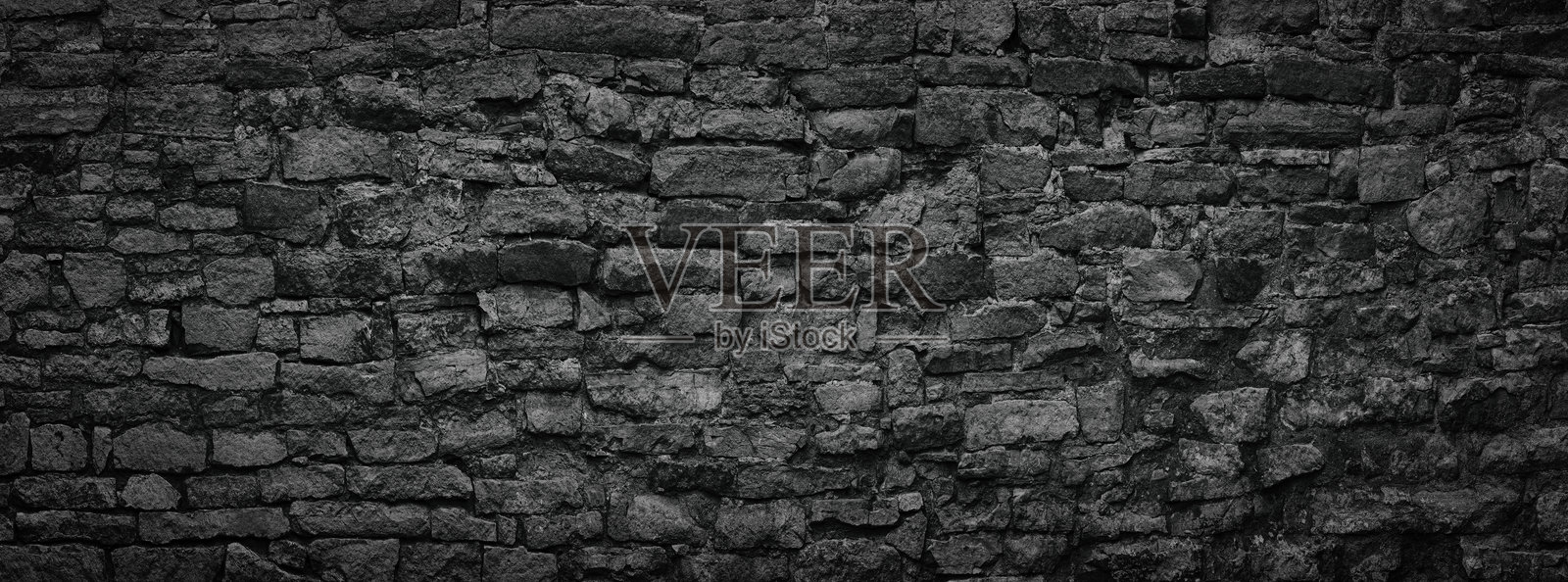 古老城堡的黑色石墙，深色的板岩砖背景照片摄影图片