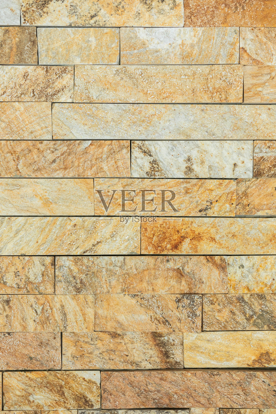 纹理自然石墙，展现温暖色调，提升其美学吸引力照片摄影图片