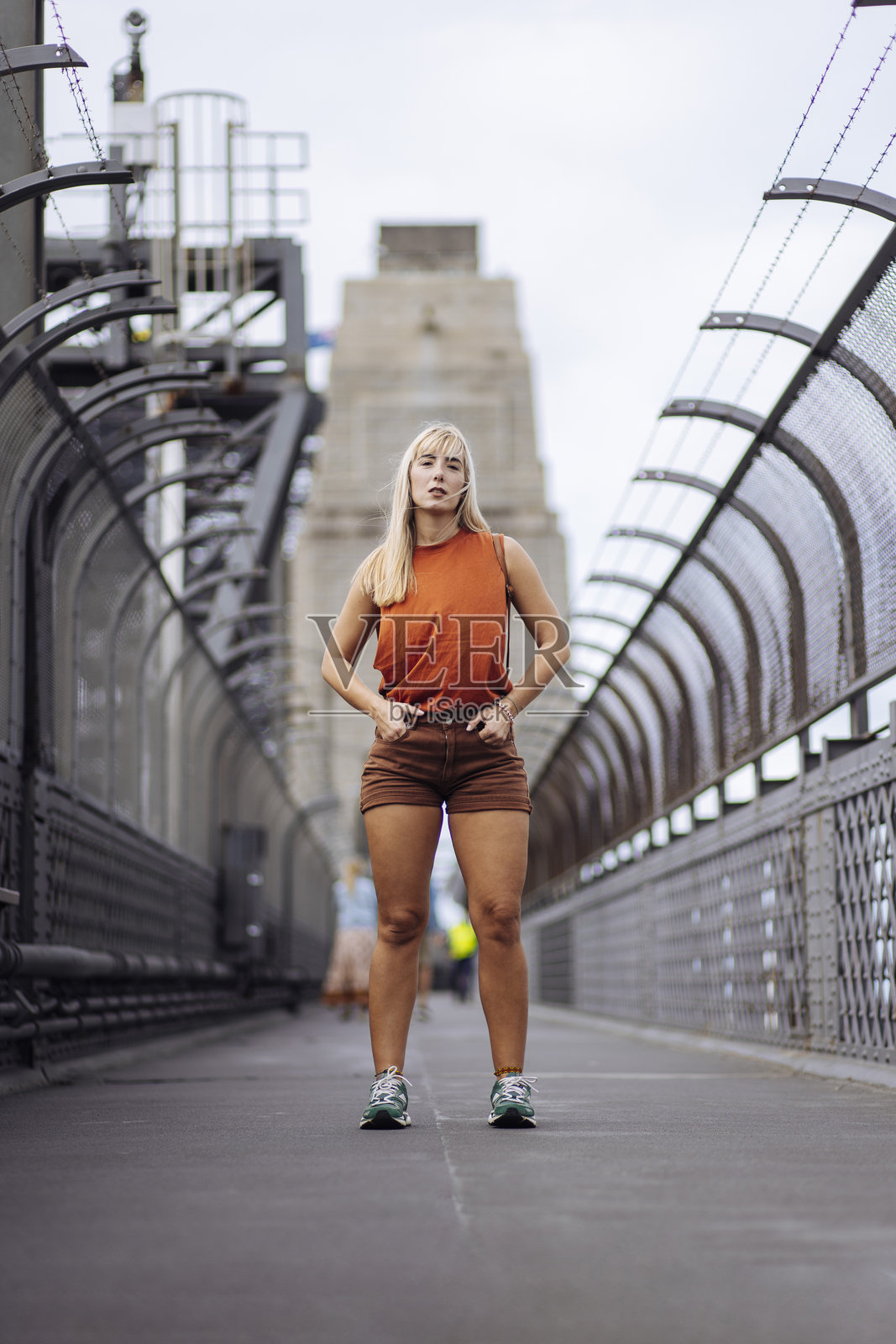 年轻金发女性在悉尼海港大桥上摆姿势照片摄影图片