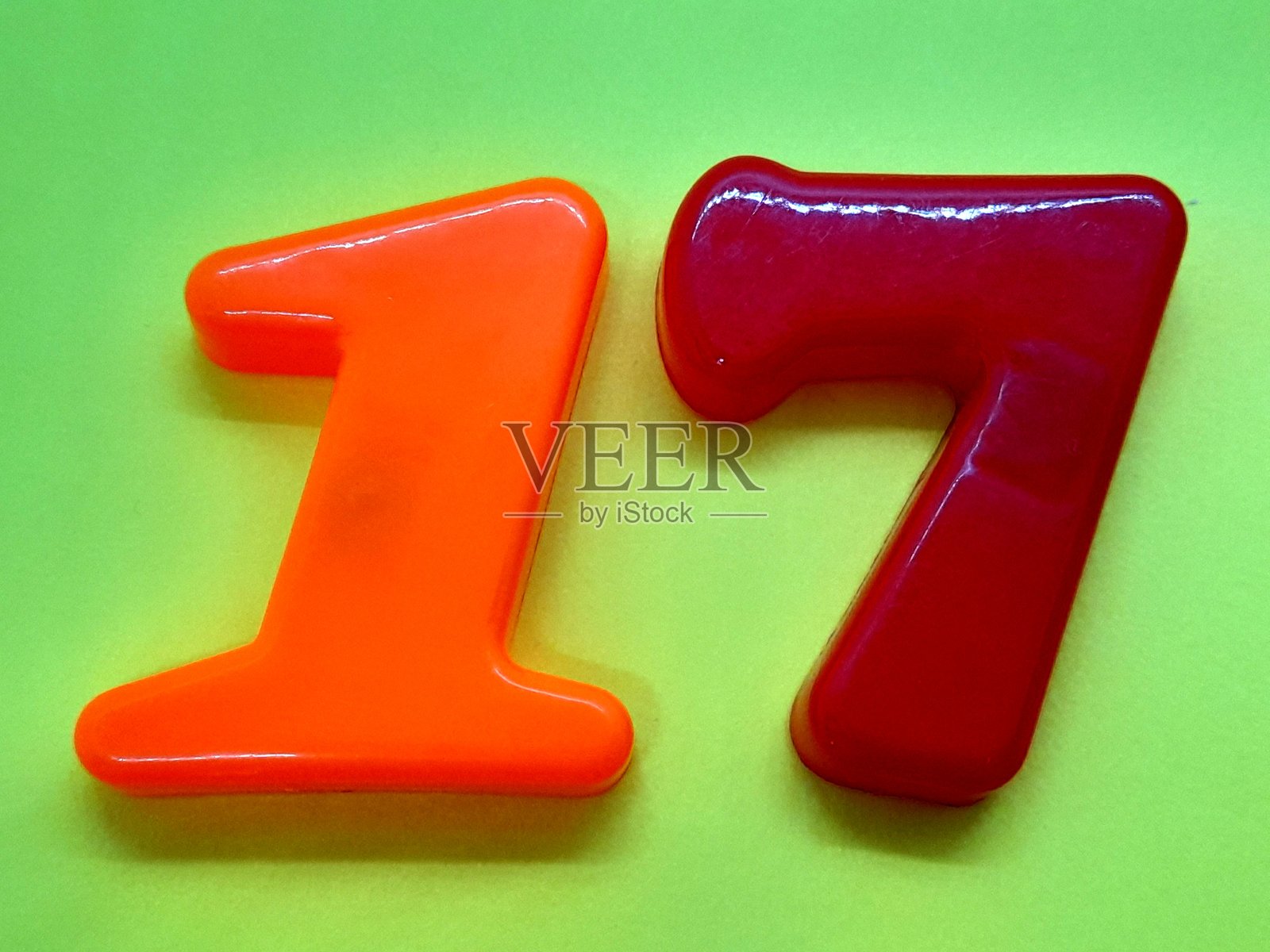 绿色背景上的数字17。照片摄影图片