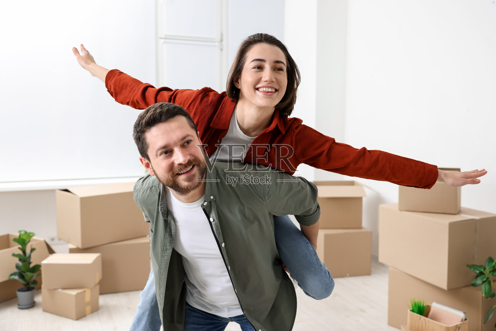 搬家日。快乐的情侣在他们的新家中享受乐趣照片摄影图片
